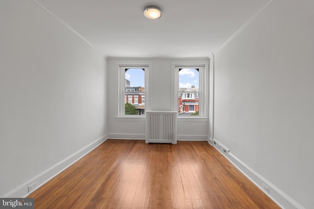 3551 13th St NW, Washington, DC 20010 - spare room with ornamental molding, hardwood / wood-style floors, and baseboards