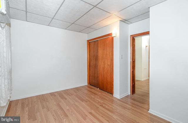 105 Ann St, Duncannon, PA 17020 - unfurnished bedroom with a drop ceiling, light wood-style floors, a closet, and baseboards