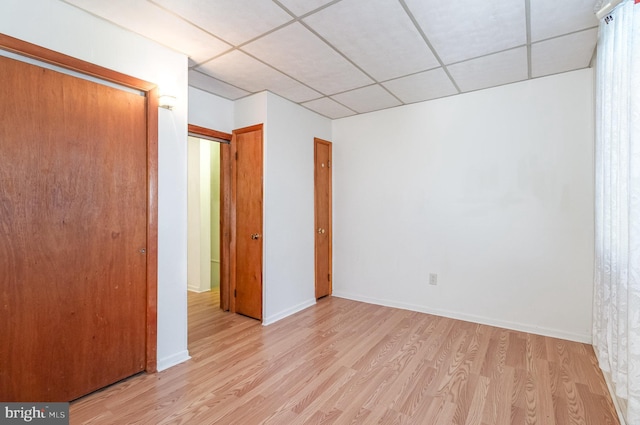 105 Ann St, Duncannon, PA 17020 - empty room with light wood finished floors, a paneled ceiling, and baseboards