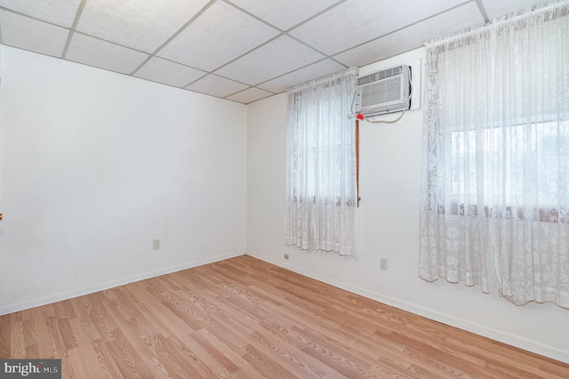 105 Ann St, Duncannon, PA 17020 - spare room featuring a paneled ceiling, an AC wall unit, wood finished floors, and baseboards
