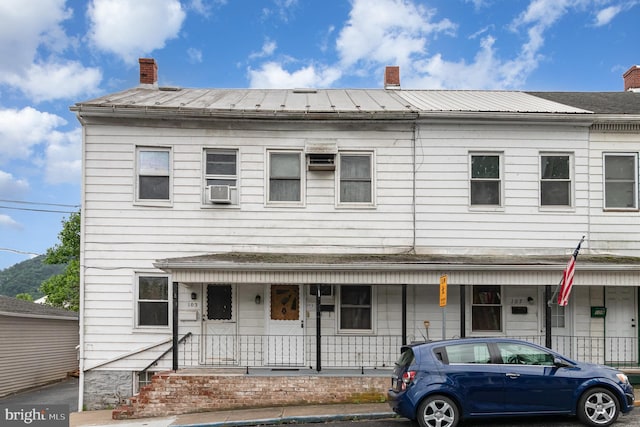 105 Ann St, Duncannon, PA 17020 - view of property with a chimney, a porch, metal roof, and a standing seam roof