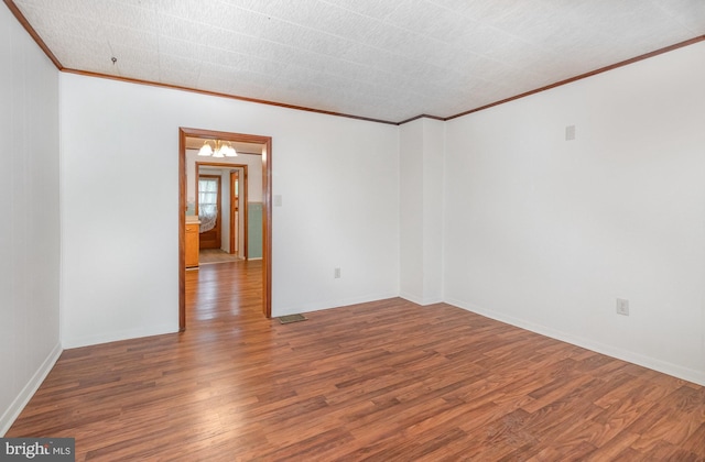 105 Ann St, Duncannon, PA 17020 - empty room featuring ornamental molding, wood finished floors, a chandelier, and baseboards