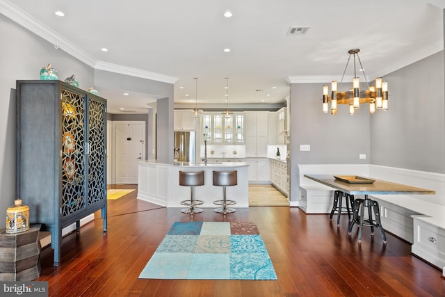 525 Belmont Bay Dr Unit 406, Woodbridge, VA 22191 - dining room featuring crown molding, a chandelier, wood-type flooring, and recessed lighting