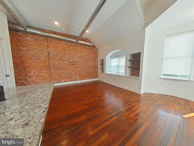 3228 W Diamond St, Philadelphia, PA 19121 - unfurnished living room featuring brick wall, hardwood / wood-style flooring, and lofted ceiling