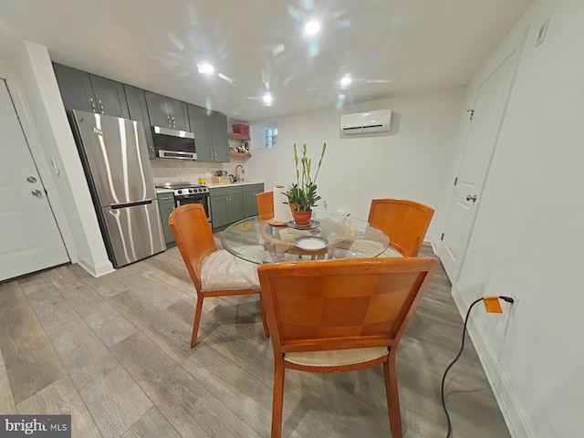 3228 W Diamond St, Philadelphia, PA 19121 - dining room featuring an AC wall unit and light wood-style flooring