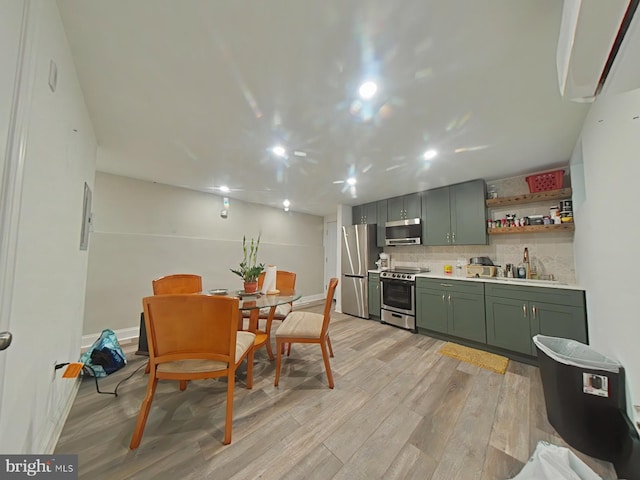 3228 W Diamond St, Philadelphia, PA 19121 - kitchen with green cabinets, appliances with stainless steel finishes, light wood-style flooring, light countertops, and tasteful backsplash