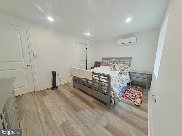 3228 W Diamond St, Philadelphia, PA 19121 - bedroom with a wall mounted air conditioner, wood finished floors, and recessed lighting