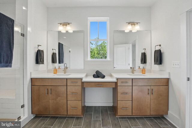 17941 Woods Overlook Dr, Dumfries, VA 22026 - bathroom featuring two vanities, wood tiled floors, and a shower stall