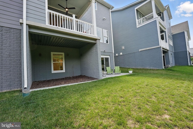 17941 Woods Overlook Dr, Dumfries, VA 22026 - back of house featuring a balcony, brick siding, a yard, and a patio