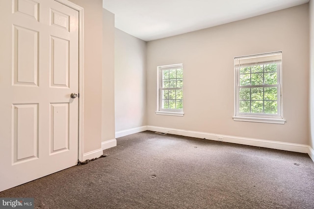 2228 W Baltimore St, Baltimore, MD 21223 - spare room featuring dark carpet, plenty of natural light, and baseboards