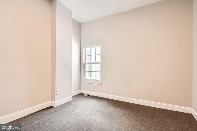 2228 W Baltimore St, Baltimore, MD 21223 - spare room featuring baseboards and dark carpet