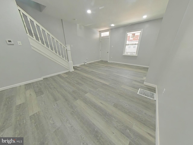134 N Hobart St, Philadelphia, PA 19139 - unfurnished living room with stairs, baseboards, wood finished floors, and recessed lighting