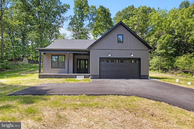 13 Connie Trl, Fairfield, PA 17320 - modern farmhouse style home featuring covered porch, a front lawn, asphalt driveway, and an attached garage