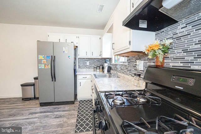536 Cormorant Dr, Voorhees, NJ 08043 - kitchen with freestanding refrigerator, gas stove, ventilation hood, a sink, and white cabinets