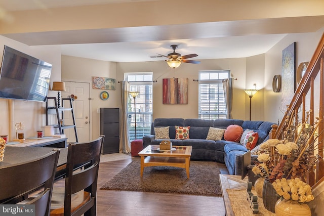 7136 Daniel John Dr, Elkridge, MD 21075 - living room featuring dark wood finished floors, a ceiling fan, and stairs