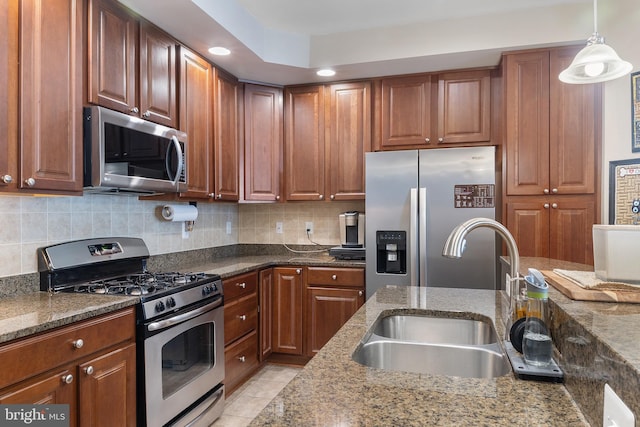 7136 Daniel John Dr, Elkridge, MD 21075 - kitchen with appliances with stainless steel finishes, dark stone countertops, tasteful backsplash, brown cabinets, and recessed lighting