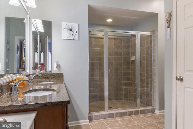 7136 Daniel John Dr, Elkridge, MD 21075 - full bath with double vanity, a shower stall, and tile patterned flooring