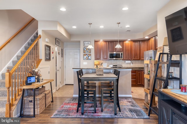 7136 Daniel John Dr, Elkridge, MD 21075 - dining area featuring stairs, wood finished floors, and recessed lighting