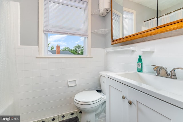 2410 Saint Clair Dr, Temple Hills, MD 20748 - bathroom featuring tile walls, vanity, toilet, a wainscoted wall, and curtained shower
