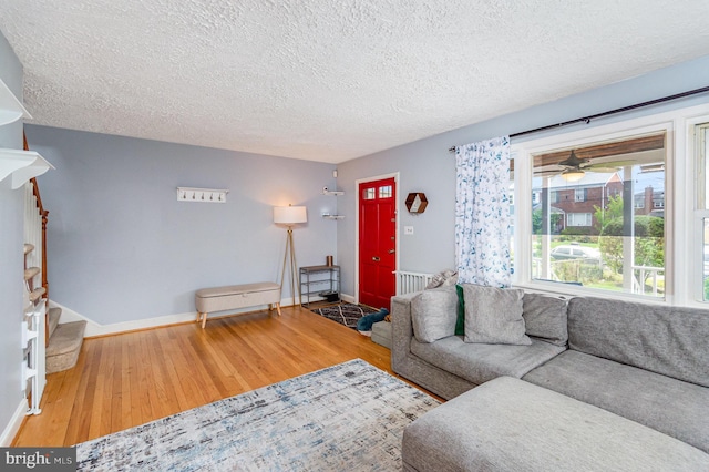 2410 Saint Clair Dr, Temple Hills, MD 20748 - living room with wood finished floors, a textured ceiling, baseboards, and a ceiling fan