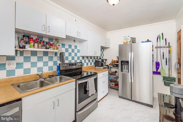2410 Saint Clair Dr, Temple Hills, MD 20748 - kitchen featuring appliances with stainless steel finishes, a sink, white cabinets, light countertops, and ornamental molding