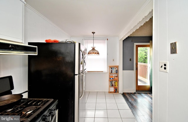 408 Spruce St, Glenolden, PA 19036 - kitchen featuring ornamental molding, freestanding refrigerator, and tile patterned floors