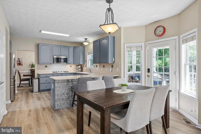 1104 Century Oak Dr, Fredericksburg, VA 22401 - dining space with light wood-style floors and a textured ceiling