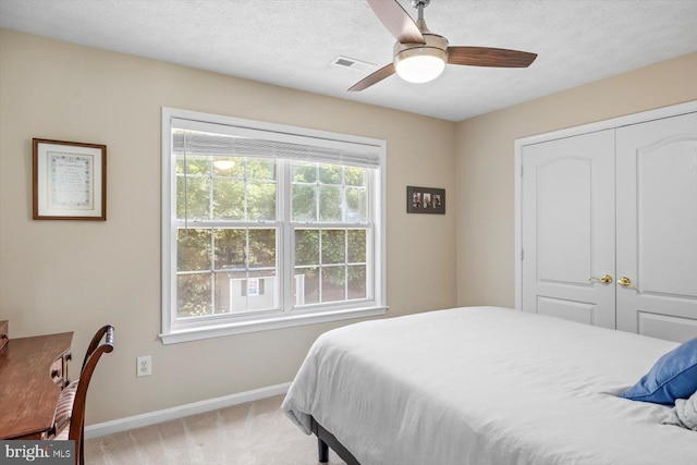 1104 Century Oak Dr, Fredericksburg, VA 22401 - bedroom featuring baseboards, light colored carpet, a textured ceiling, a closet, and a ceiling fan