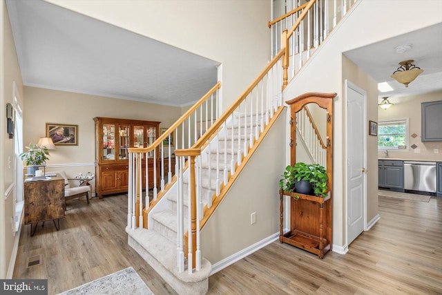 1104 Century Oak Dr, Fredericksburg, VA 22401 - staircase featuring wood finished floors, crown molding, and baseboards