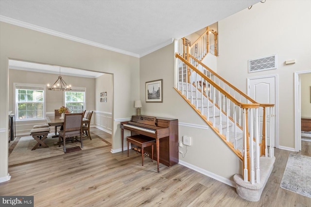 1104 Century Oak Dr, Fredericksburg, VA 22401 - stairs with wood finished floors, a chandelier, crown molding, and baseboards