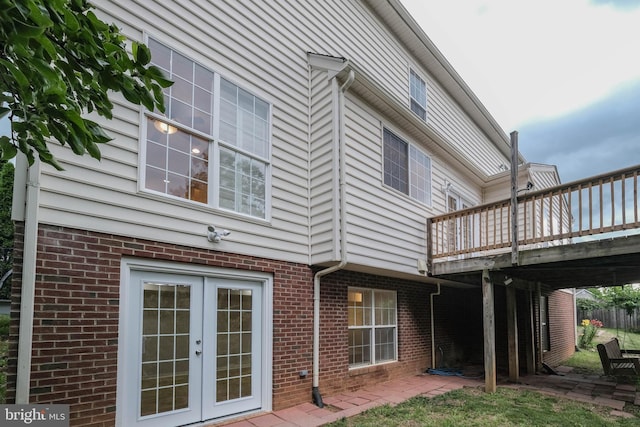 1421 Pickett Ct, Front Royal, VA 22630 - back of property with french doors, a wooden deck, brick siding, and a patio area