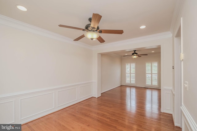 1421 Pickett Ct, Front Royal, VA 22630 - unfurnished room with crown molding, wainscoting, ceiling fan, light wood-style flooring, and a decorative wall