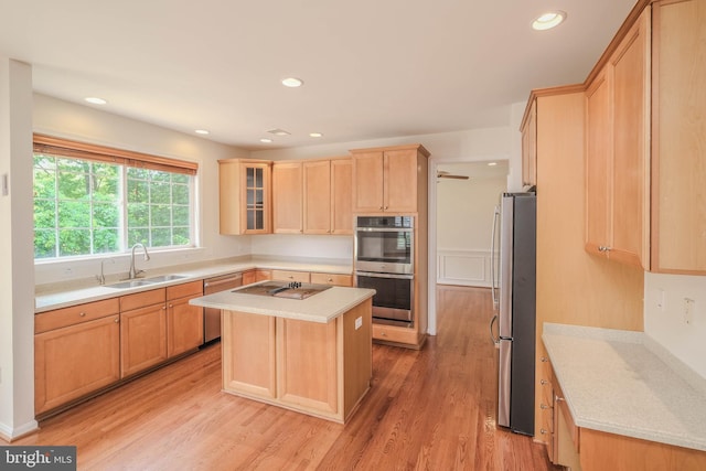 1421 Pickett Ct, Front Royal, VA 22630 - kitchen featuring appliances with stainless steel finishes, light brown cabinetry, light countertops, a center island, and light wood-style floors