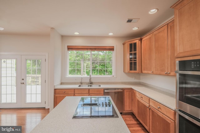 1421 Pickett Ct, Front Royal, VA 22630 - kitchen with stainless steel appliances, light wood-style flooring, light countertops, recessed lighting, and glass insert cabinets
