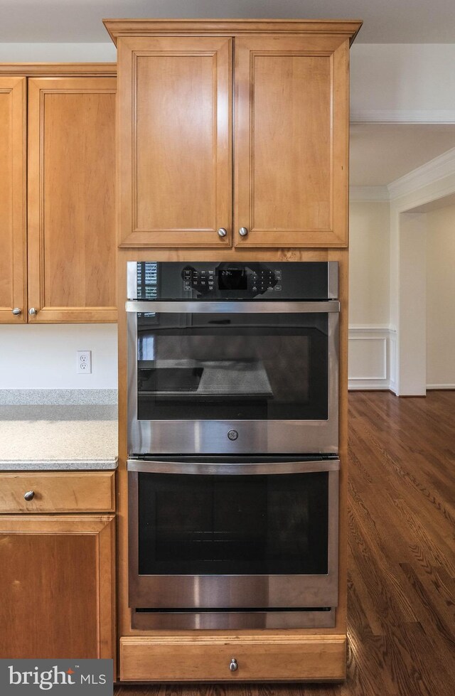 1421 Pickett Ct, Front Royal, VA 22630 - kitchen featuring stainless steel double oven, ornamental molding, light countertops, and dark wood-style flooring