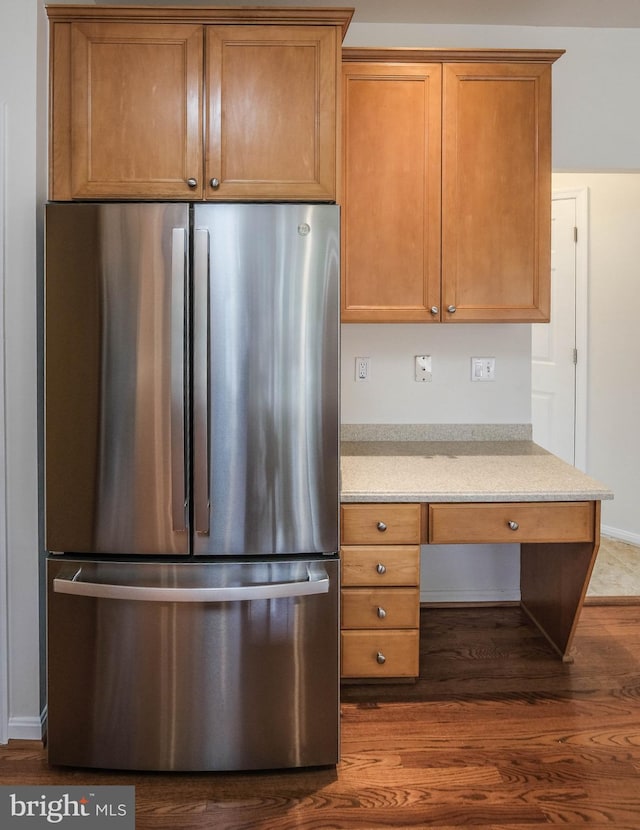1421 Pickett Ct, Front Royal, VA 22630 - kitchen featuring freestanding refrigerator, dark wood-type flooring, brown cabinetry, and light stone countertops