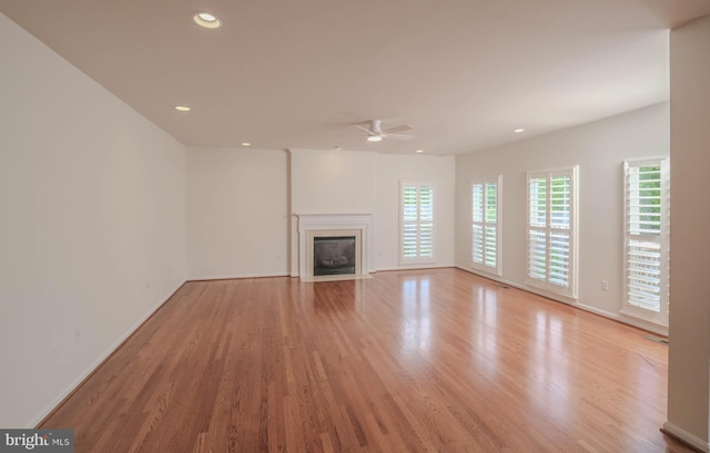 1421 Pickett Ct, Front Royal, VA 22630 - unfurnished living room with a ceiling fan, light wood-style floors, a fireplace with flush hearth, and recessed lighting