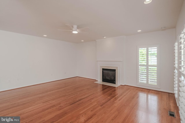 1421 Pickett Ct, Front Royal, VA 22630 - unfurnished living room featuring a fireplace with flush hearth, ceiling fan, light wood-type flooring, and recessed lighting