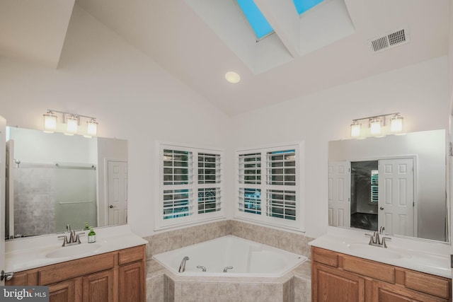 1421 Pickett Ct, Front Royal, VA 22630 - bathroom featuring a skylight, a bath, two vanities, vaulted ceiling, and a shower with door
