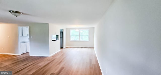 3 New Coach Ln, Willingboro, NJ 08046 - unfurnished living room with light wood-type flooring and baseboards