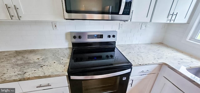 3 New Coach Ln, Willingboro, NJ 08046 - kitchen with stainless steel electric range oven, white cabinets, decorative backsplash, and light stone countertops