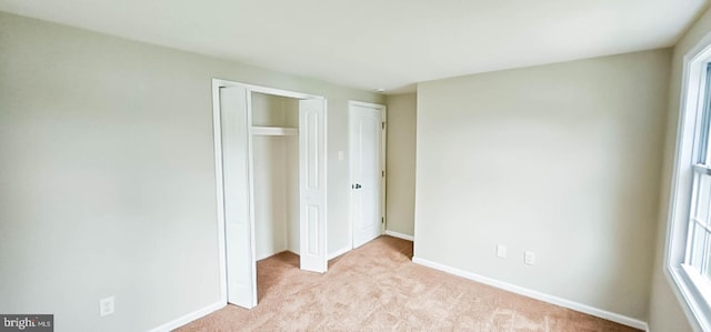 3 New Coach Ln, Willingboro, NJ 08046 - unfurnished bedroom featuring light colored carpet, baseboards, and multiple closets