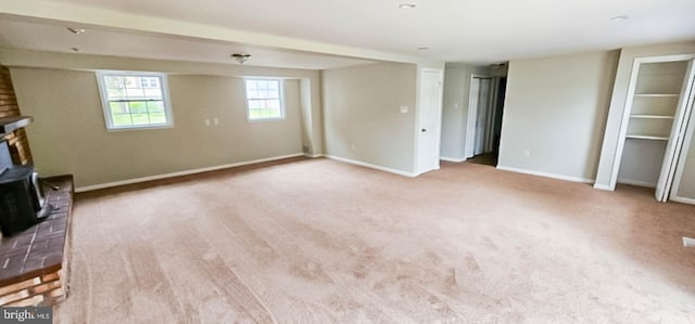 3 New Coach Ln, Willingboro, NJ 08046 - unfurnished living room featuring a wood stove, carpet flooring, and baseboards