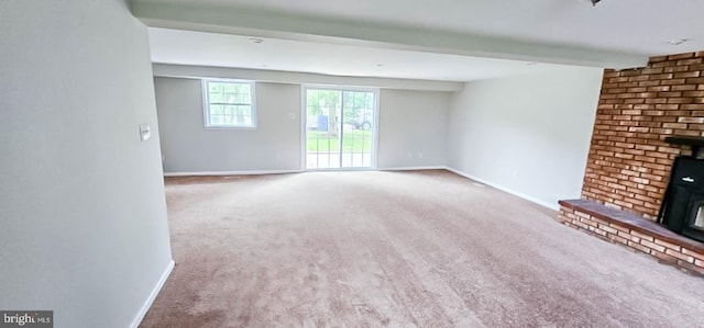 3 New Coach Ln, Willingboro, NJ 08046 - unfurnished living room featuring a wood stove, carpet, baseboards, and beam ceiling