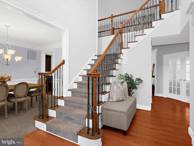 13801 Racetrack Field Ct, Bowie, MD 20720 - stairs featuring a chandelier, wood finished floors, ornamental molding, a high ceiling, and baseboards