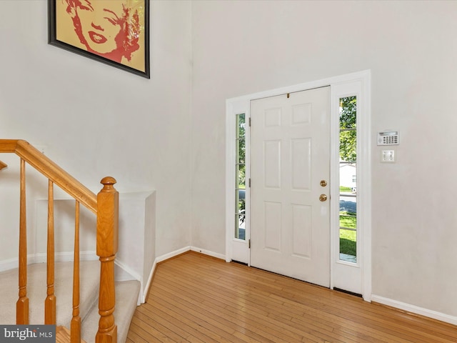 6418 Flintlock Ct, Eldersburg, MD 21784 - foyer entrance with hardwood / wood-style floors, stairway, and a high ceiling
