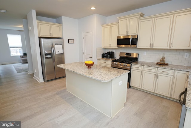 36063 Auburn Way, Millsboro, DE 19966 - kitchen with appliances with stainless steel finishes, cream cabinetry, light wood-style flooring, tasteful backsplash, and recessed lighting