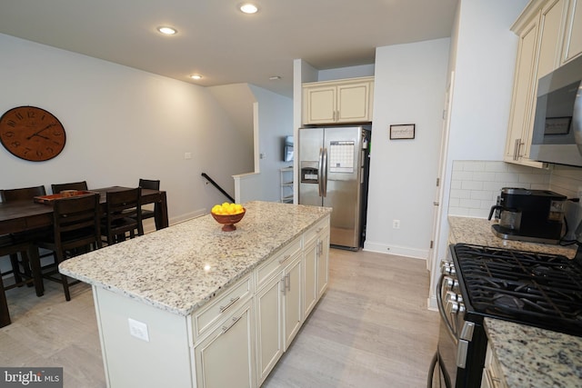 36063 Auburn Way, Millsboro, DE 19966 - kitchen with stainless steel appliances, cream cabinets, backsplash, light stone counters, and recessed lighting