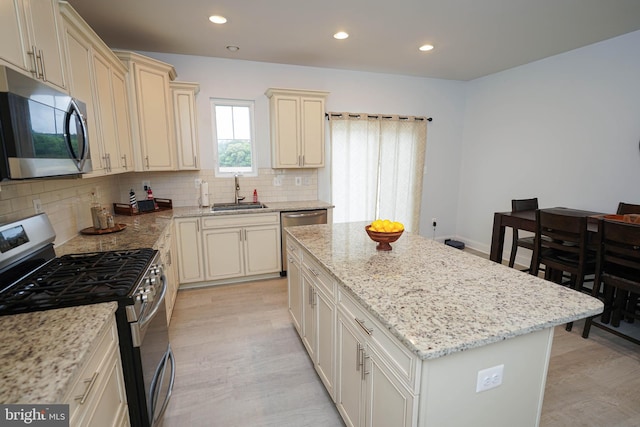 36063 Auburn Way, Millsboro, DE 19966 - kitchen with appliances with stainless steel finishes, a sink, a kitchen island, backsplash, and recessed lighting