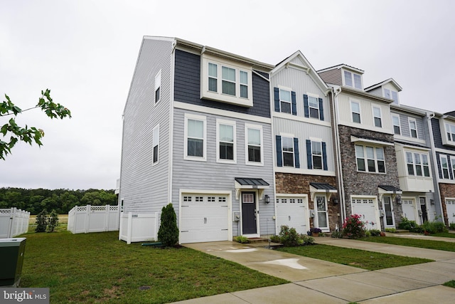 36063 Auburn Way, Millsboro, DE 19966 - townhome / multi-family property with driveway, an attached garage, and stone siding